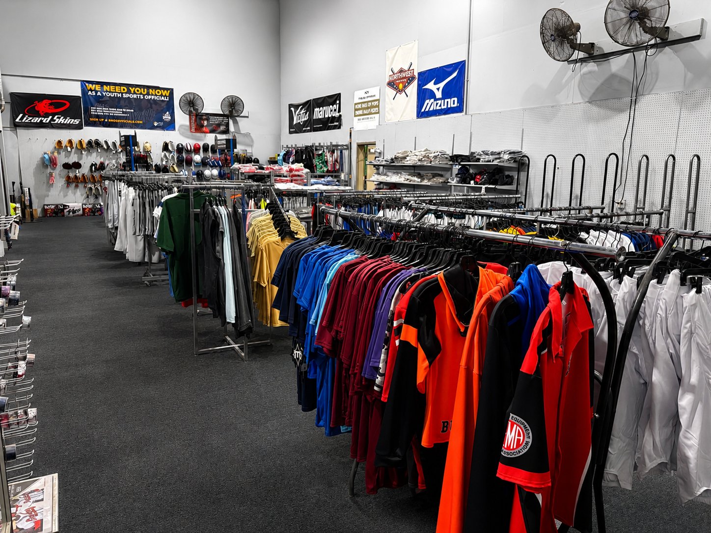 Inside Turf Sporting Goods with racks of team jerseys, cleats and vendor banners